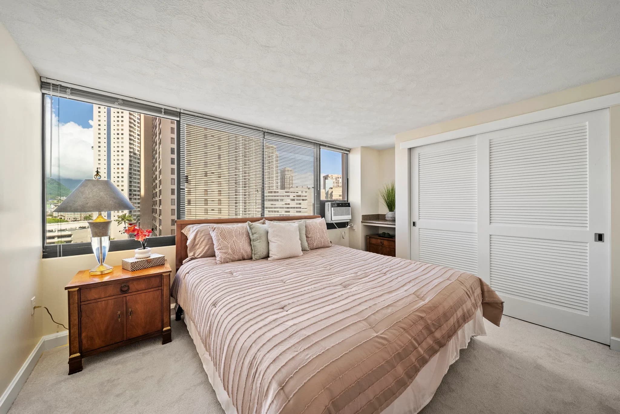 Spacious bedroom with mirrored closet doors