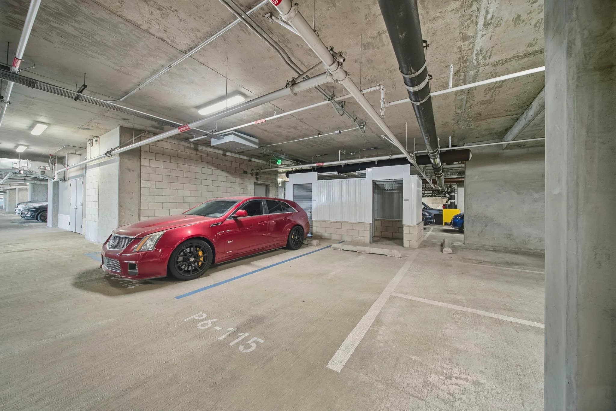 Covered parking garage with assigned stalls at Aeʻo.