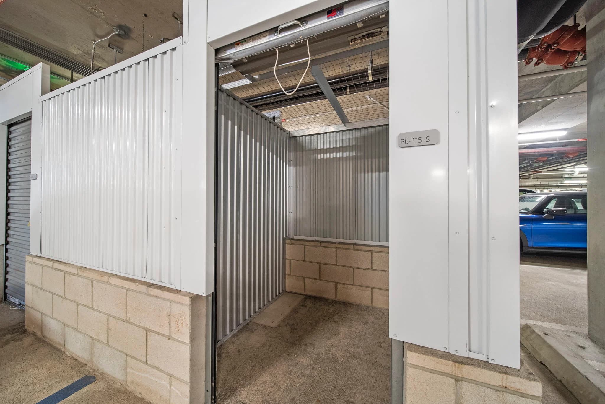 External storage unit located adjacent to the parking stall.
