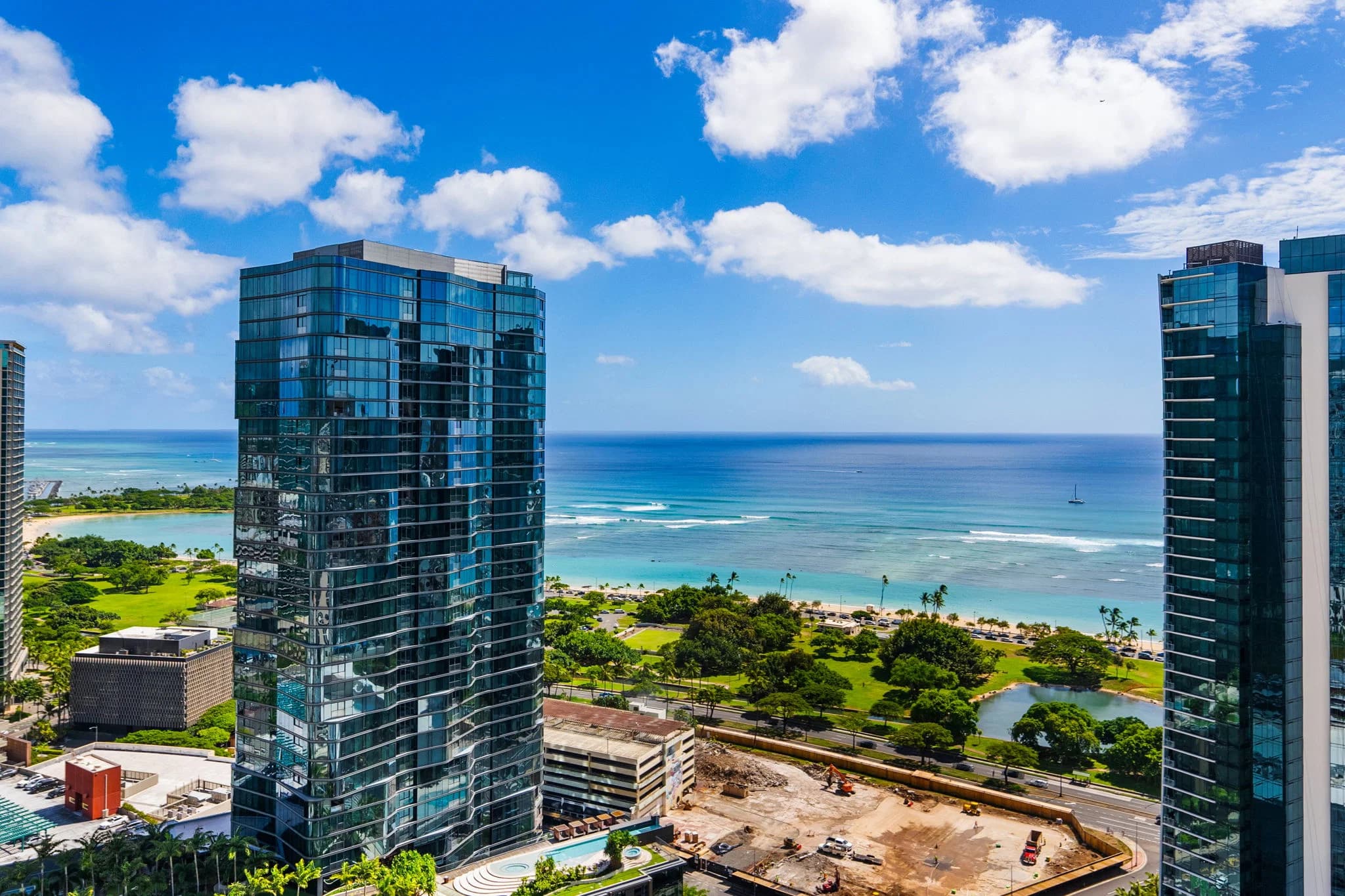 Elevated coastline and city view with neighboring Ward Village towers and the ocean beyond.