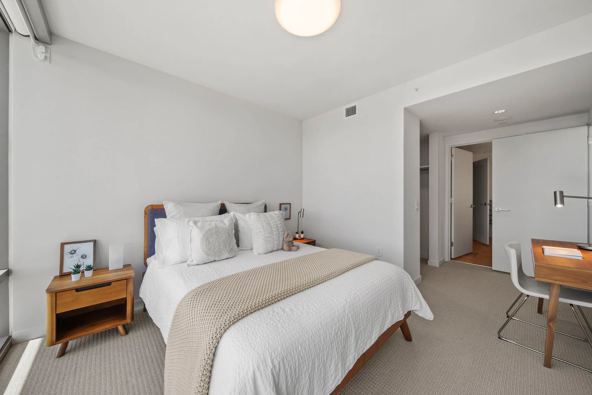 Spacious bedroom with desk and nightstands