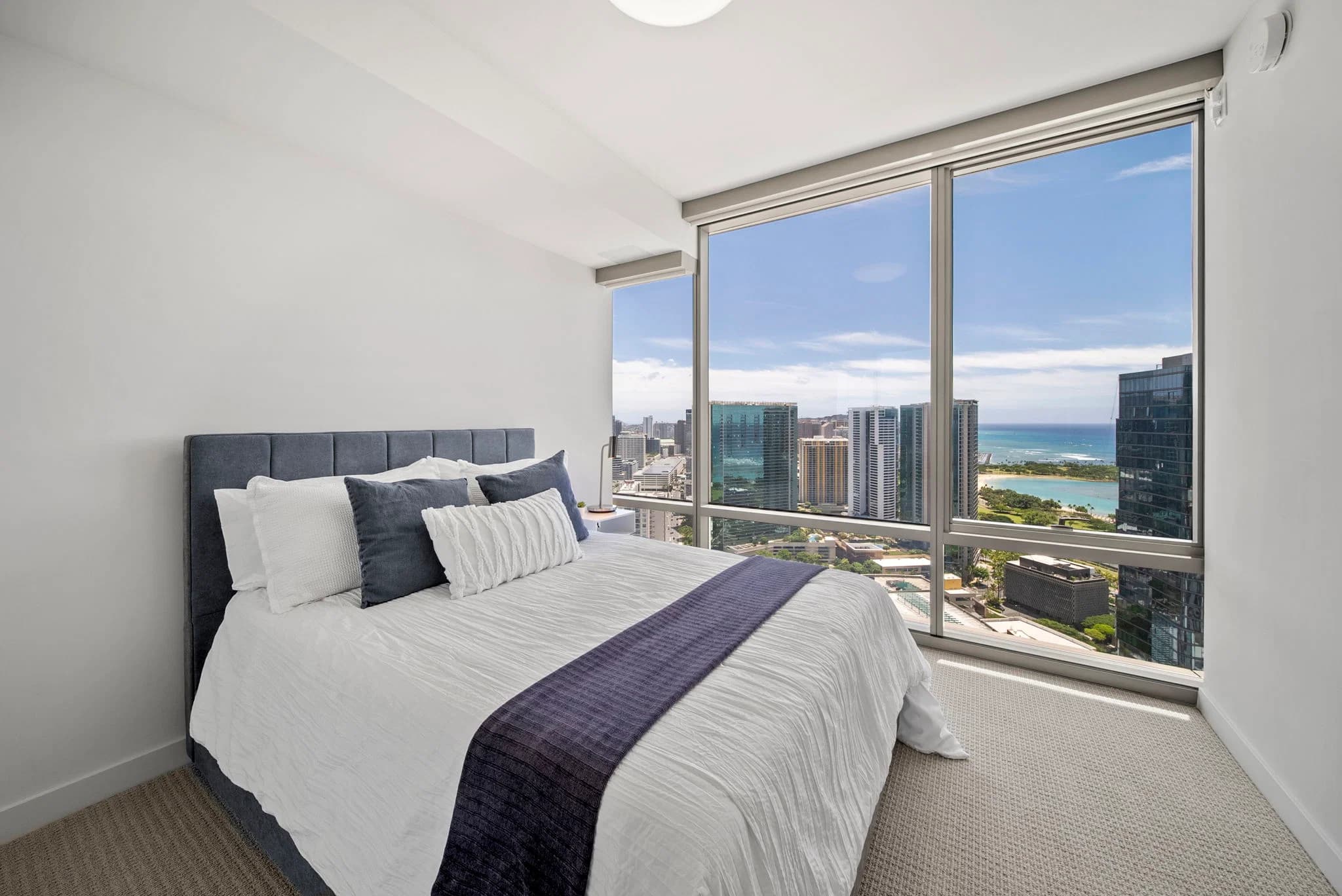 Guest bedroom with city and ocean views