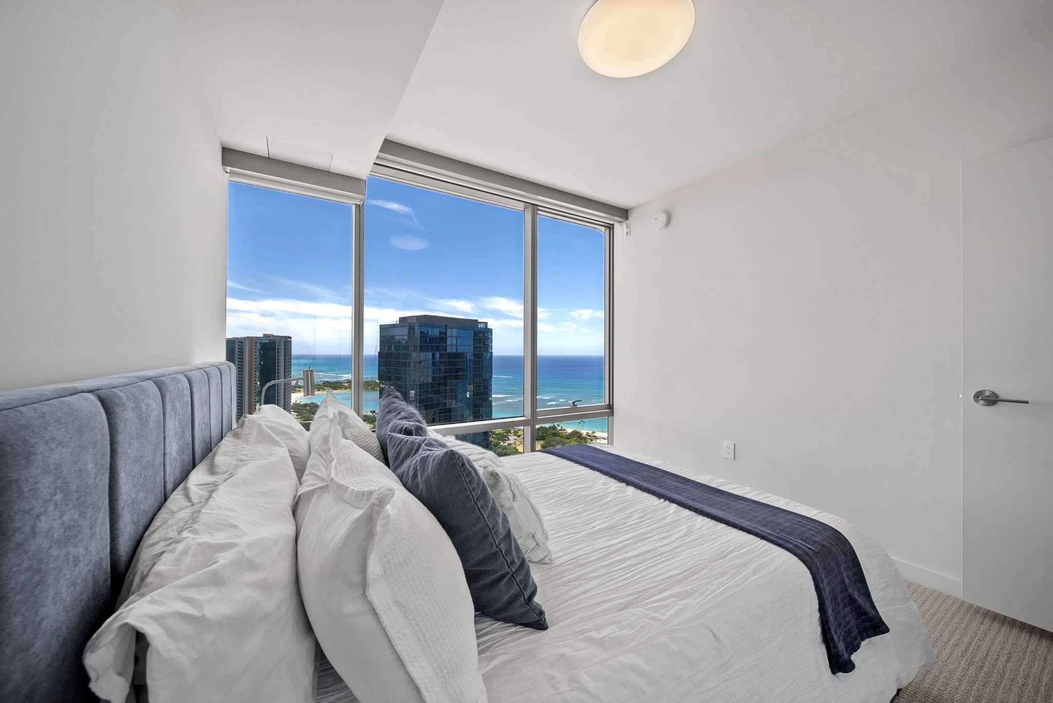 Bedroom featuring floor-to-ceiling glass windows