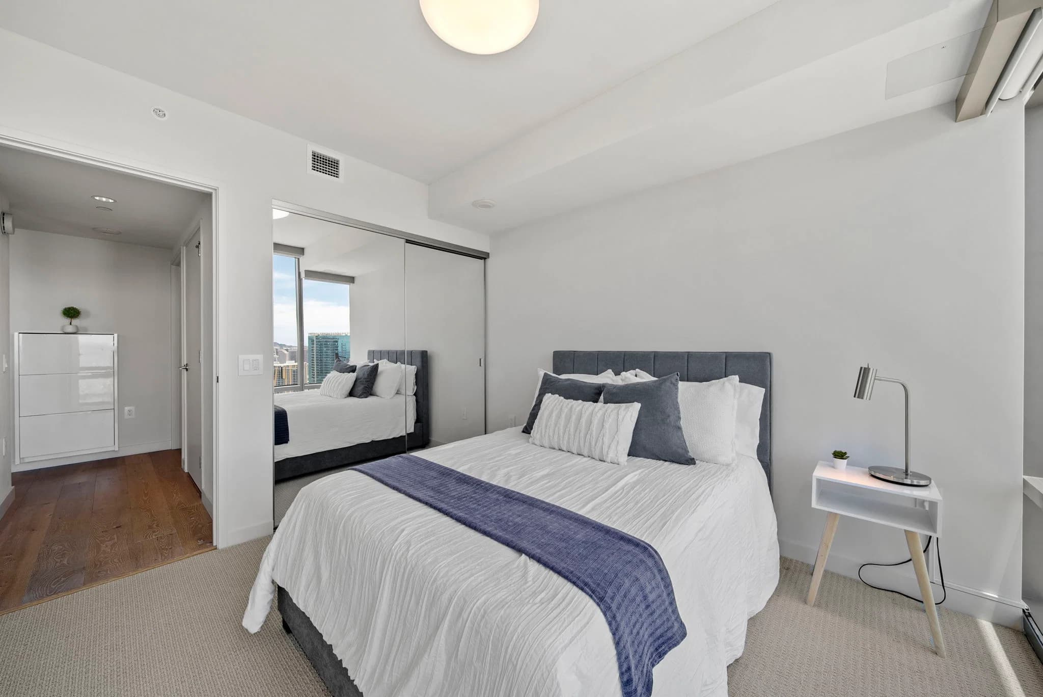 Guest bedroom with mirrored closet doors