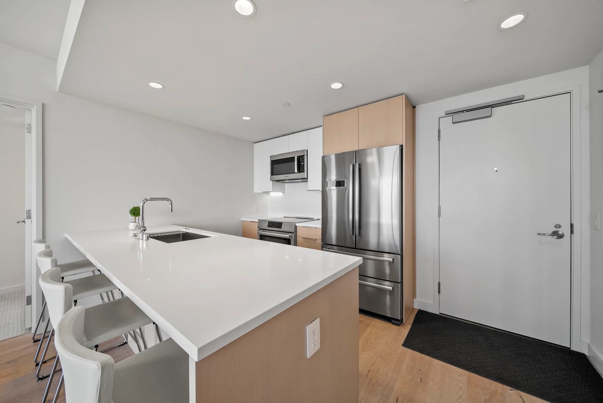 Quartz kitchen island with stainless steel appliances